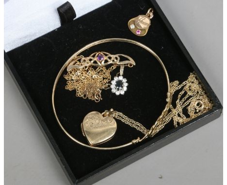 A collection of gold jewellery; a 9ct gold openwork bangle, an amethyst necklet, sapphire pendant on chain, heart shaped lock