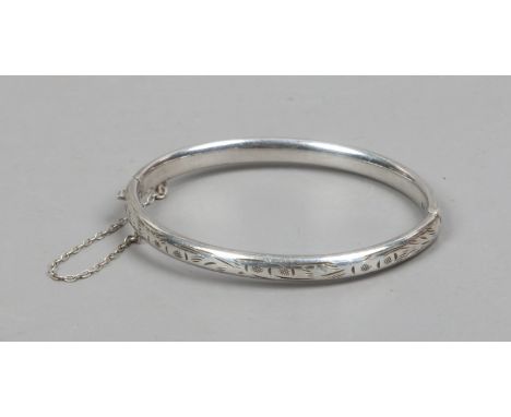 An engraved silver bangle by Charles Horner, hallmarks worn.