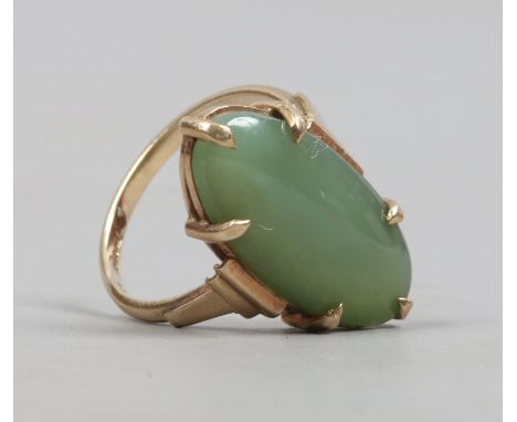 A 9ct gold ring claw set with a navette form jade panel, size N.