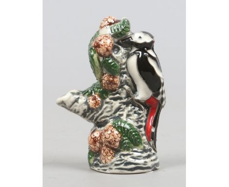 A Moorcroft model of a great spotted woodpecker feeding on a branch designed by Rachel Bishop first quality.