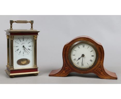 A brass cased West German eight day carriage clock striking on a bell along with an inlaid mahogany mantel clock.