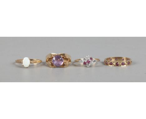 Four 9ct gold dress rings including amethyst opal, ruby and cubic zirconia.