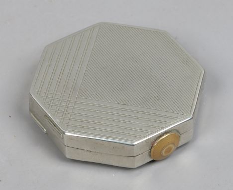 A vintage French silver plated octagonal compact by Montral with watch winder powder dispensing mechanism and engine turned e