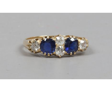 A Victorian 18ct gold six stone sapphire and diamond ring, assayed London 1890, size R.