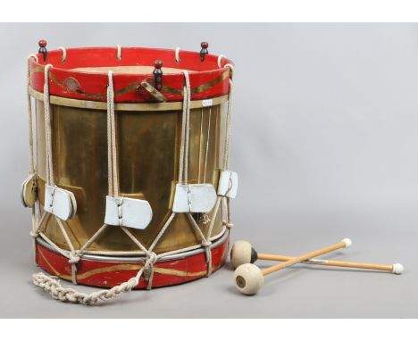 A vintage brass and painted wood marching snare drum by John Grey & Sons of London with two beaters.