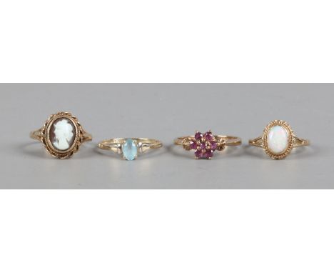 Four 9ct gold dress rings including cameo, opal, ruby and blue topaz.