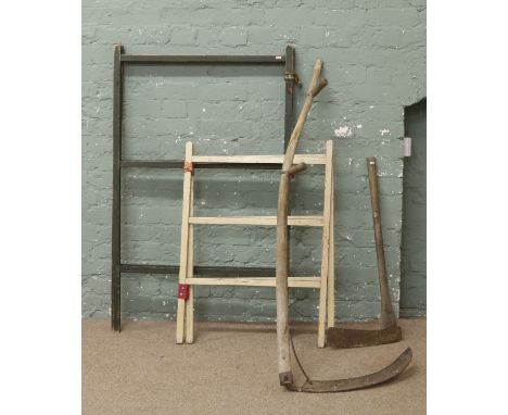 Two vintage painted clothes horses along with a vintage scythe and axe.