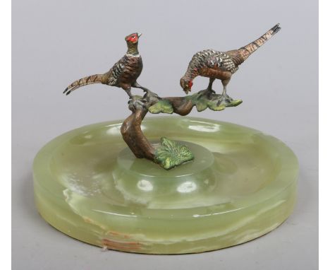 A cold painted bronze group, possibly Austrian. Formed as two pheasants perched on a tree branch, raised on an onyx dish.