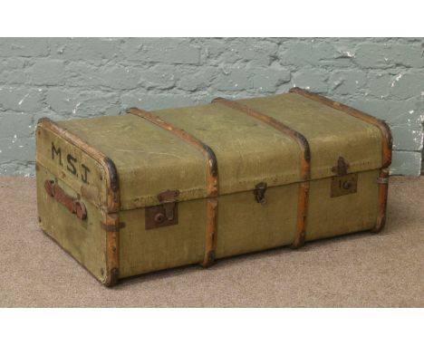 A vintage canvas and wood bound travelling trunk.