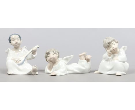 Three Lladro figures formed as angels one playing a lute.