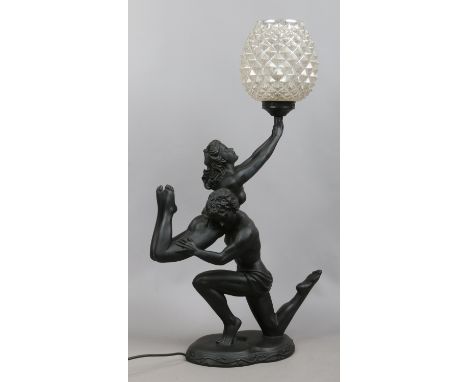 A ceramic figural tablelamp formed as semi naked dancers.