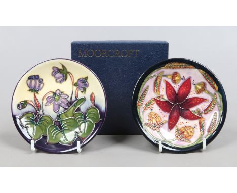 Two Moorcroft pin dishes one in the Hepatica pattern by Emma Bossons the other in the Delonix pattern both by Shirley Hayes i