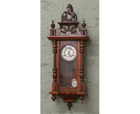 A Victorian oak cased springer wall clock with brass and enamel dial Roman numeral baton markers striking on a coiled gong.