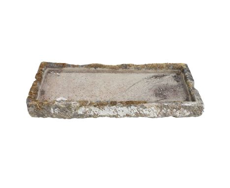 A 19TH CENTURY RECLAIMED HAND CARVED STONE TROUGH. the weathered hand carved stone trough, dating to the 19th century, it fea
