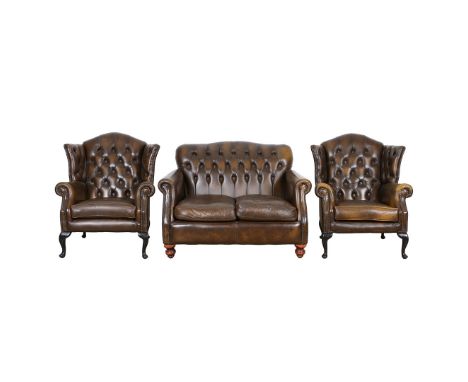 A THOMAS LLOYD THREE PIECE CHESTERFIELD LOUNGE SUITE. comprising of a two seater settee and two wingback armchairs, settee 90