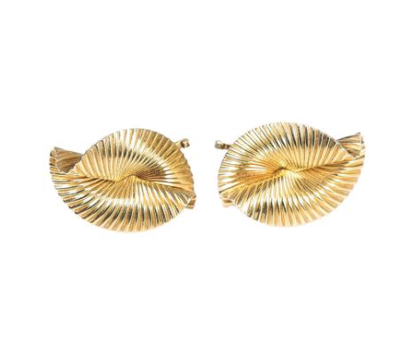 CARTIER: A PAIR OF 14 CARAT GOLD EARRINGS BY GEORGE SCHULER. Of fluted swirled oval form, the clip backs stamped "CARTIER 14K