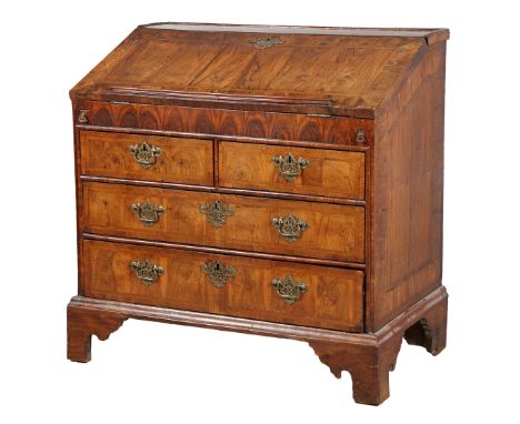 A RARE QUEEN ANNE WALNUT OYSTER VENEER BUREAU, CIRCA 1710. Having a shallow gallery to the top with herringbone cross-banding