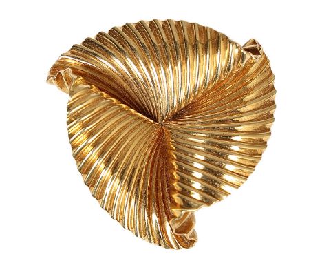 CARTIER: AN 18 CARAT GOLD BROOCH BY GEORGE SCHULER. In the form of three swirling fluted fans, stamped verso "CARTIER 18KT 15
