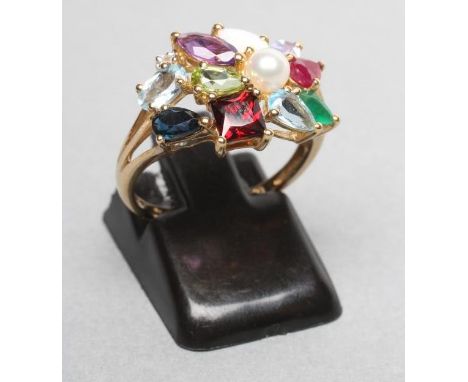 A CONTINENTAL "TUTTI FRUTTI" COCKTAIL RING, claw set with an aquamarine, garnet, cultured pearl, peridot and other semi preci