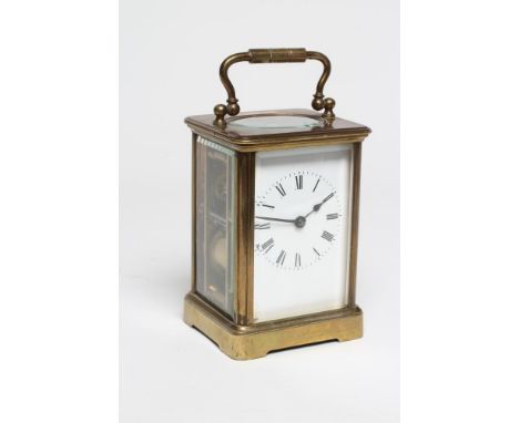 A BRASS CASED CARRIAGE CLOCK, the twin barrel movement with platform escapement striking on a gong, white enamel dial with Ro