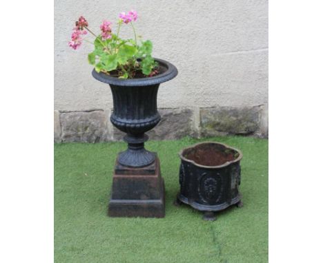 A VICTORIAN CAST IRON URN, of fluted campana form with egg and dart moulded rim, raised on tapering stepped square plinth, 15