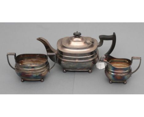 A THREE PIECE TEA SERVICE, maker Hutton & Sons, Birmingham 1932, of plain rounded oblong form raised on four ball feet, compr