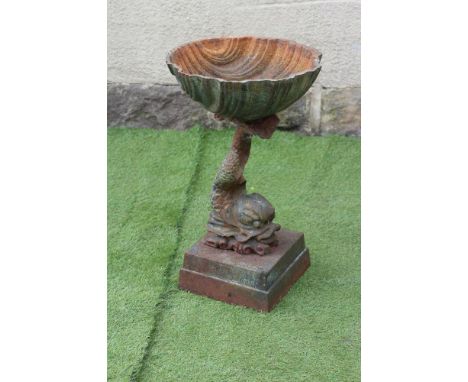 A CAST IRON PLANTER modelled as a dolphin supporting a scallop shell, raised on moulded square base, 15 1/2" x 26" (Est. plus