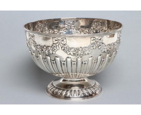 A LATE VICTORIAN ROSE BOWL, maker William Haseler, London 1901, of semi fluted circular form, repousse with ribbon tied garla