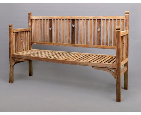 AN ARTS AND CRAFTS STYLE TEAK BENCH, the slatted back with straight top rail and pierced with trefoils, similar sides, slatte