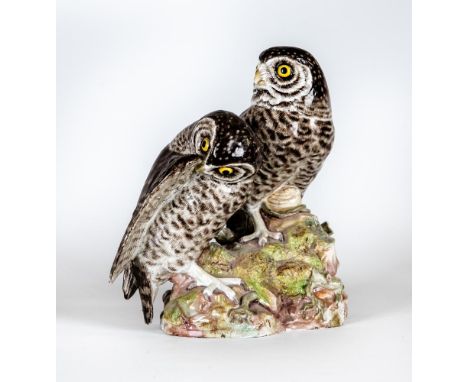 TWO MEISSEN PORCELAIN OWLS, 19th century, both perched upon a naturalistically moulded rocky outcrop against tree branches, a