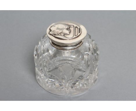 A LATE VICTORIAN CLEAR GLASS INKWELL, maker Wm. Hutton & Sons, London 1901, the plain mount with hinged cover chased and repo