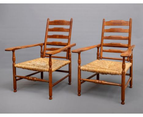 A PAIR OF GORDON RUSSELL ARTS AND CRAFTS STYLE FRUITWOOD ARMCHAIRS, c.1900, the adjustable ladder back with turned uprights a