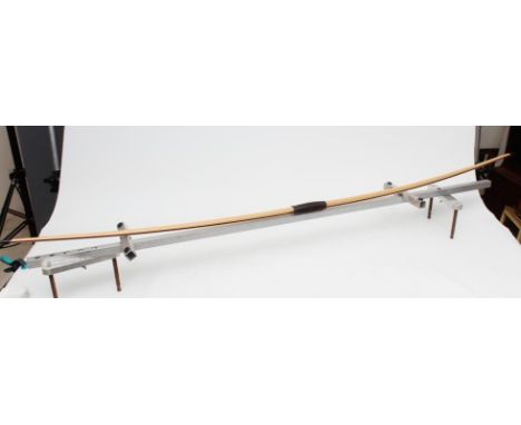 A BICKERSTAFFE LONG BOW, of laminated form with horn tips and leather grip, BH: 6 1/2" MAX, DL: 29" MAX DW: 40# @ 28", 75" ti