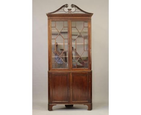A GEORGIAN MAHOGANY STANDING CORNER CUPBOARD, third quarter 18th century, the moulded and dentil inlaid cornice with scrolled