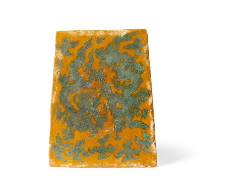  CHINESE YELLOW AND GREEN-GLAZED RECTANGULAR 'DRAGON' TILE MING DYNASTY OR LATER 明或以後 黃地綠釉刻雙龍戲珠圖磚of trapezoidal rectangular f