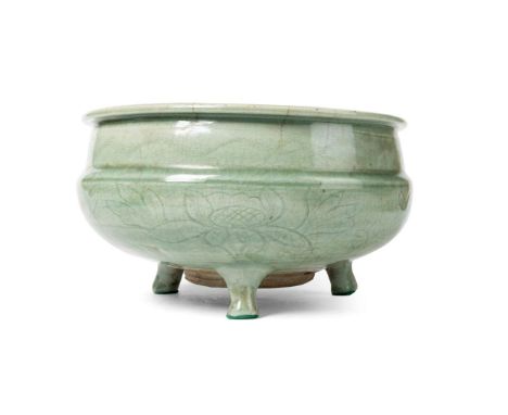  CHINESE LONGQUAN CELADON-GLAZED TRIPOD CENSER MING DYNASTY 明 龍泉窰青釉刻花卉紋三足爐sturdily potted with a compressed bulbous body, sup
