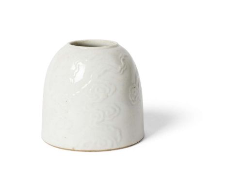  CHINESE WHITE-GLAZED CARVED 'BEEHIVE' WATERPOT QING DYNASTY, 19TH CENTURY 清 康熙款 白釉暗花祥雲紋馬蹄尊carved to the exterior with billow
