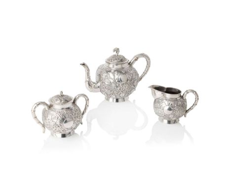  CHINESE EXPORT SILVER 'CHRYSANTHEMUM' THREE-PIECE TEA SERVICE TUCK CHANG, SHANGHAI, CA. 1870-1920 清末民初 「TC」、「声」錘印款 外銷銀菊紋茶壺、蓋