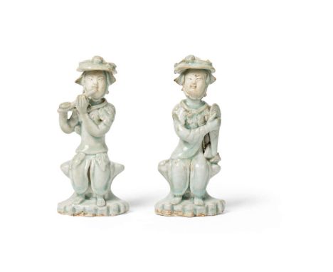  TWO CHINESE QINGBAI 'MUSICIAN' FIGURES MING DYNASTY 明 青白釉童子奏樂擺件（共兩件）one depicted playing a flute, the other with a percussio