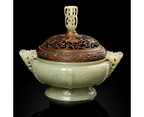  CHINESE CELADON JADE ARCHAISTIC GUI-FORM CENSER QING DYNASTY, 18TH-19TH CENTURY 清 青玉雕仿古饕餮紋雙螭耳簋式爐 帶透雕玉鈕木蓋supported on a tall 