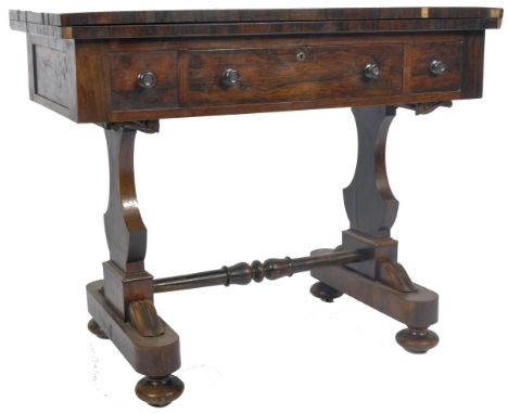 An early 19th Century George III rosewood&nbsp;games / card table. The table having a fold over top with red felt lining and 
