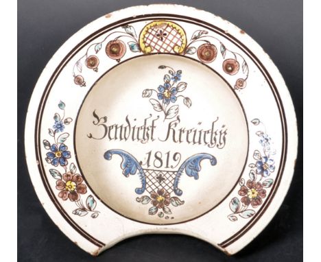 A 19th Century Dutch Delftware tin glazed earthenware barbers dish with hand painted floral sprays and central notation readi