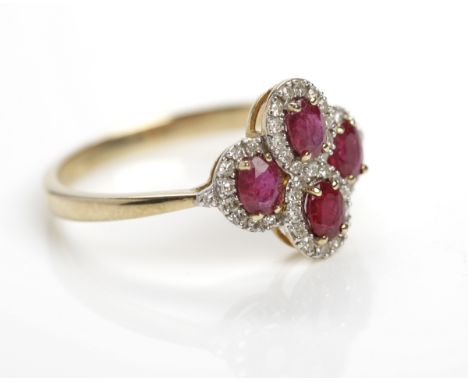 RUBY AND DIAMOND DRESS RING
the quatrefoil form bezel with four oval rubies surrounded by diamonds, in nine carat gold, size 