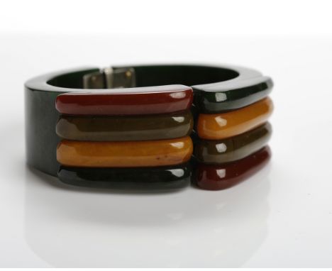 RARE ART DECO 'PHILADELPHIA' BAKELITE HINGED BANGLE
formed by a dark green body, hinged centrally, with overlaid sections of 