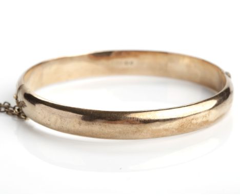 NINE CARAT ROSE GOLD BANGLE
engraved with a foliate decoration, hallmarked for nine carat gold, 8.8g