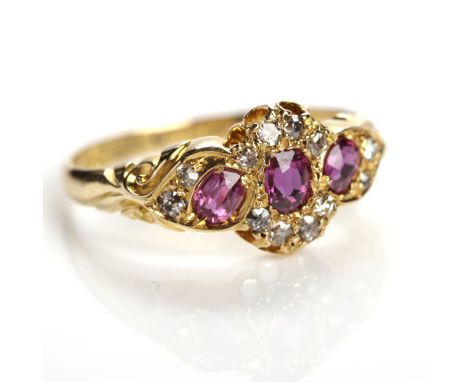 VICTORIAN RUBY AND DIAMOND RING
set with three oval rubies, the outer two set at an angle, the setting with round old cut dia