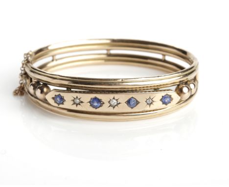 VICTORIAN SAPPHIRE AND DIAMOND BANGLE
set with alternating sapphires and diamonds in star settings, marked for nine carat gol