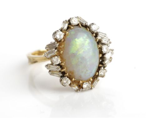 LARGE OPAL AND DIAMOND CLUSTER RING
with a central oval cabochon opal measuring 15.5mm x 12mm, surrounded by brilliant and ba