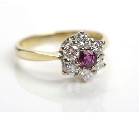RUBY AND DIAMOND CLUSTER RING
the central round ruby approximately 0.27 carats, surrounded by brilliant cut diamonds totallin