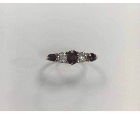 RUBY AND DIAMOND FIVE STONE RING
set with three rubies and two diamonds, in a scrolling setting, in eighteen carat gold, size